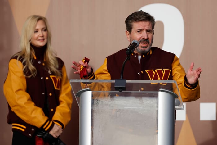 Washington Commanders co-owner Dan Snyder speaks as co-owner Tanya Snyder